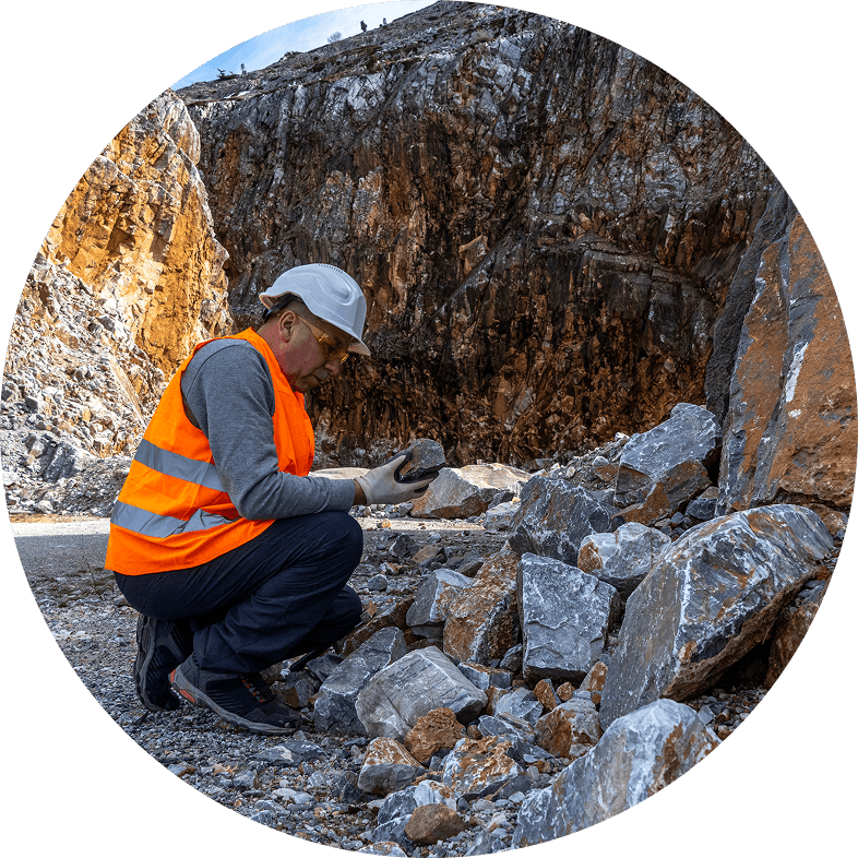 A Mining operations expert examining rock samples for viable minieral content A Mining operations expert examining rock samples for viable minieral content